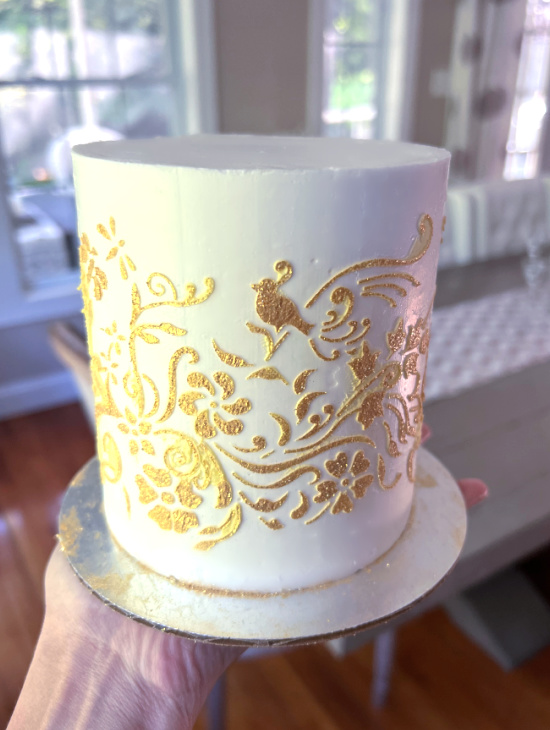 Gold glitter stenciling on buttercream cakeheads